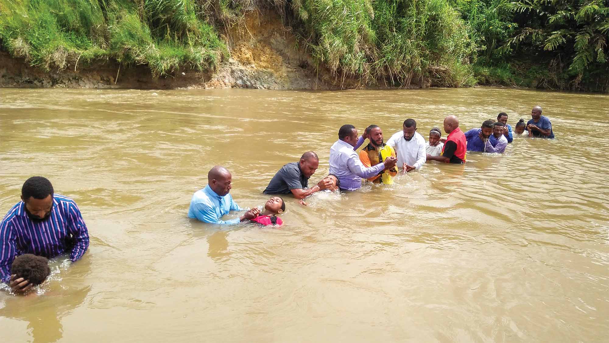 A group of Christians are baptized in a river in Papua New Guinea.