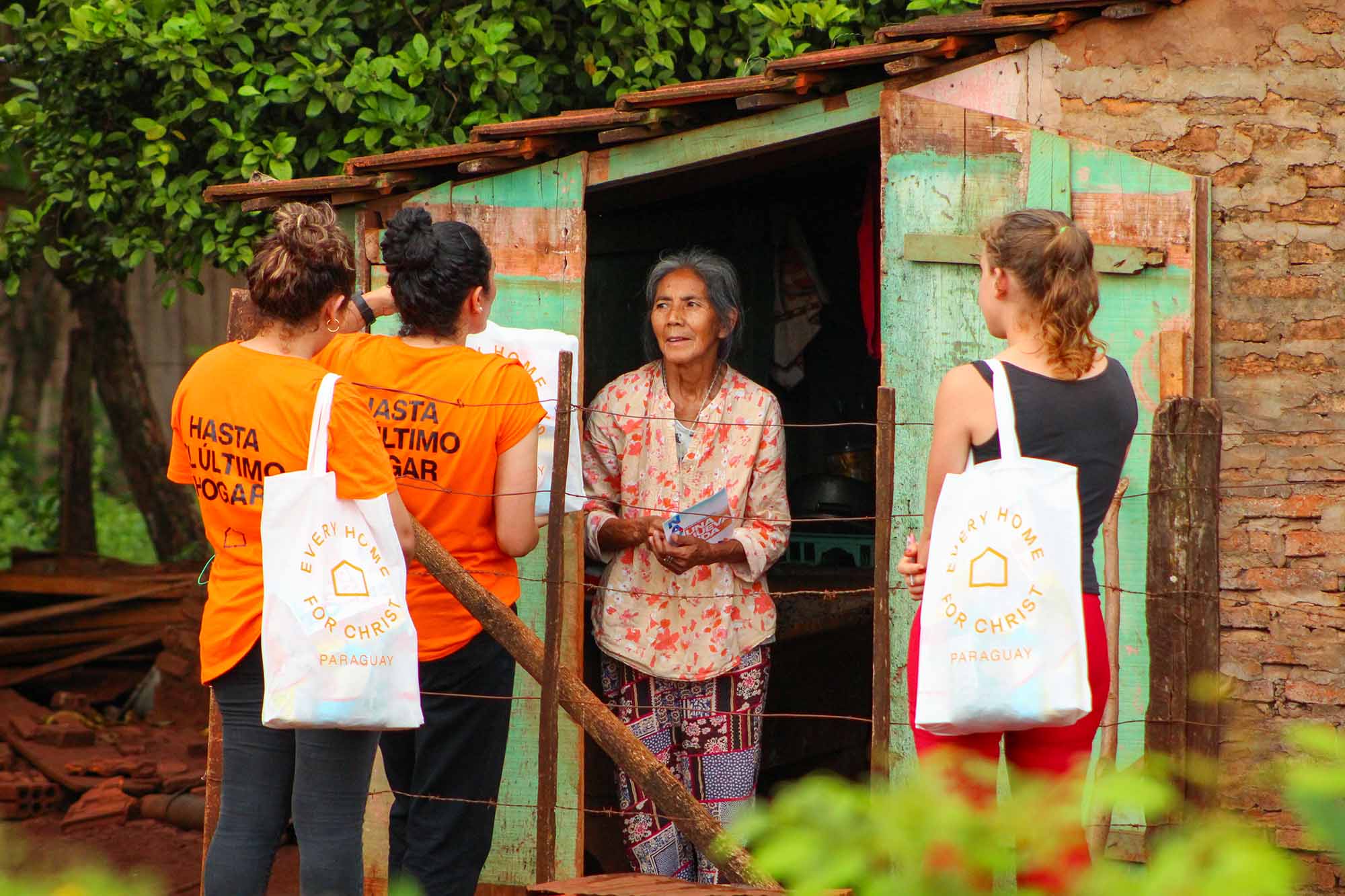 Volunteers in a foreign country bring gospel messaging door to door.