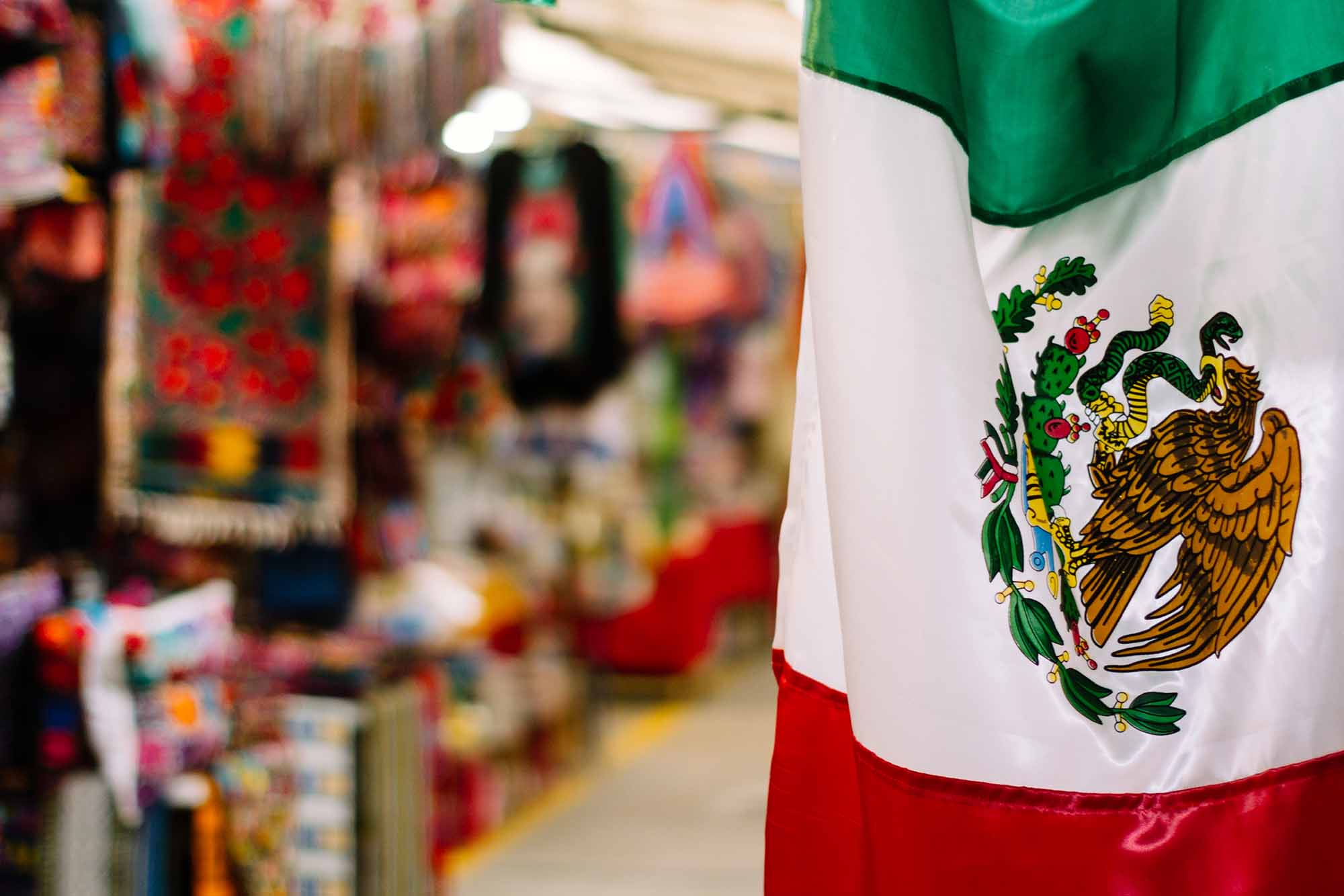 The Mexican flag hanging in a storefront