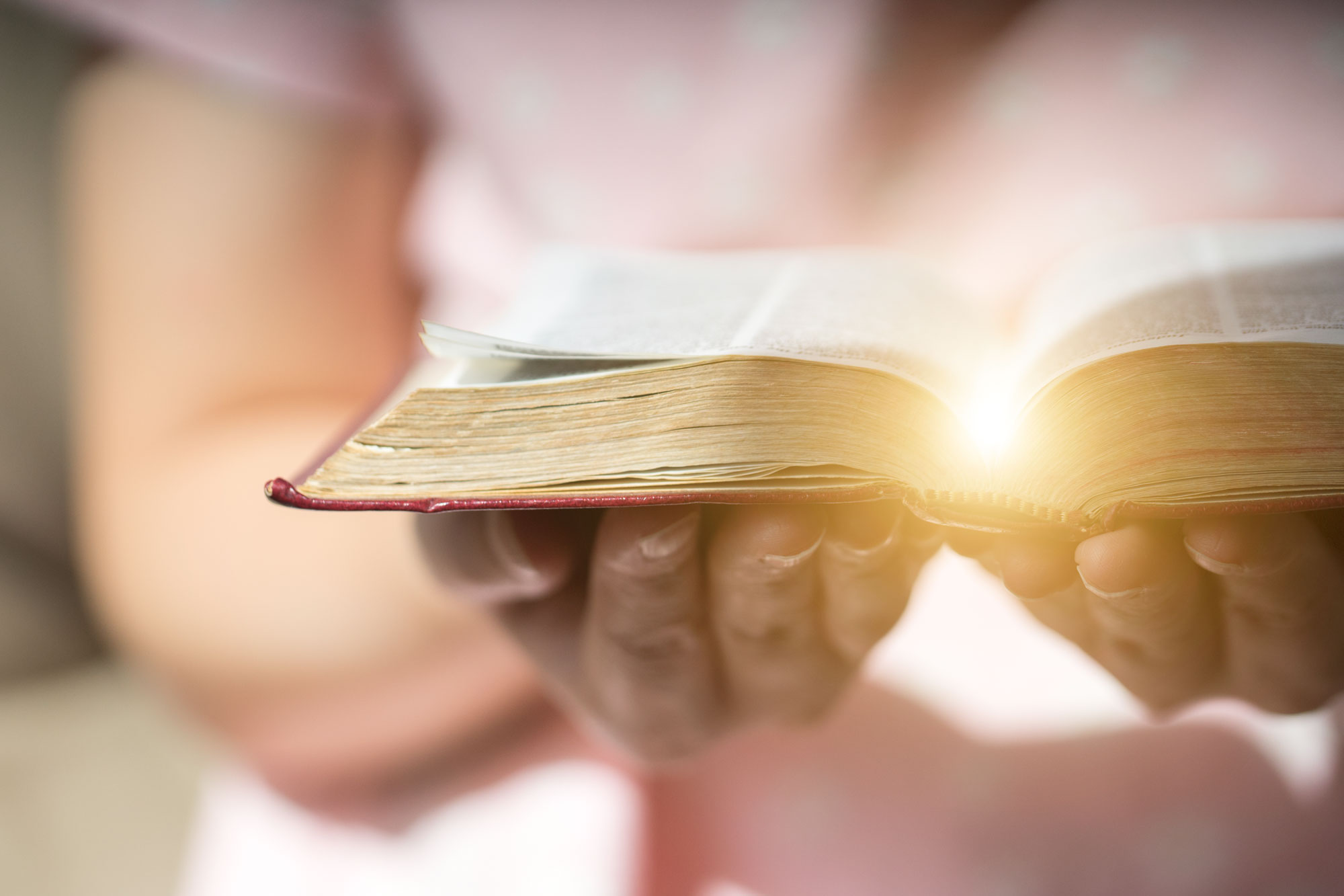 A woman holds an open Bible